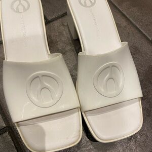 White Mules and Clogs with Smooth Synthetic Material. Good used condition